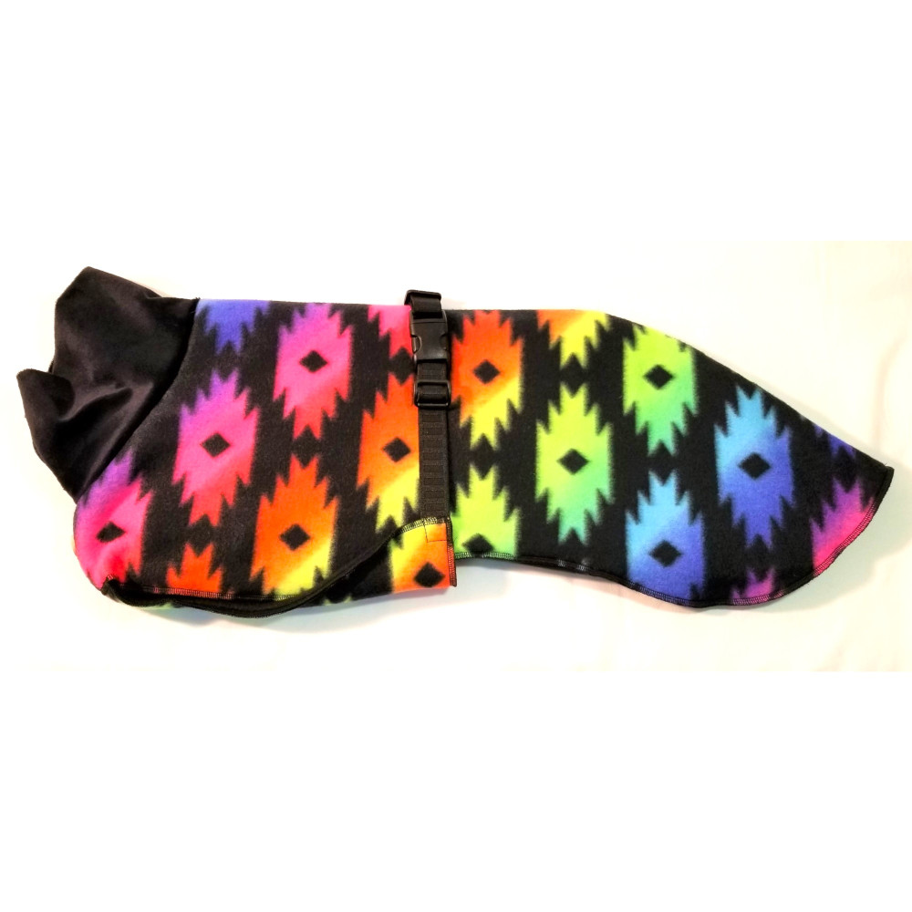 FC3278 at1000 "The coat is generous, covering the hindquarters for warmth. A breast piece comes through the front legs and protects the entire chest area - great if your dog is curled up in a crate waiting for you. Fleece inside and out keeps your dog warm and toasty in nasty weather. The collar is also fleece. Two sizes are available - Medium and Large. The medium fits most whippets up to 32 pounds. The larger coat is for the males, or a girl with a longer body. It fits whippets up to 45 pounds. And a big bonus is that fleece is easy to care for – machine wash and dry. "